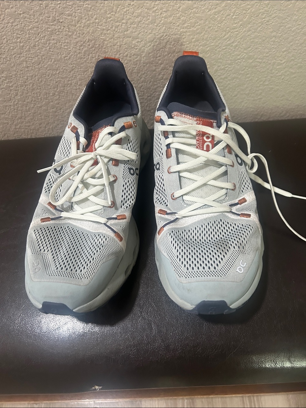 On Running Men’s Athletic Shoes in Light Gray with Orange Accents